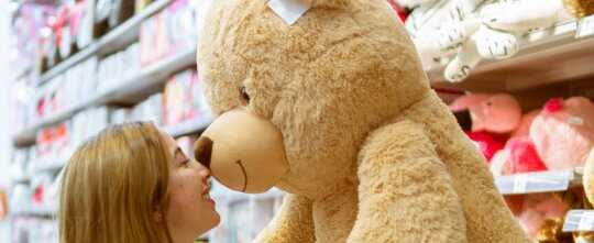 Woman Carrying Bear Plush Toy Inside Store